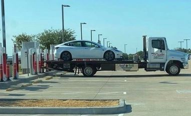 Tesla towed to a charging station.JPG